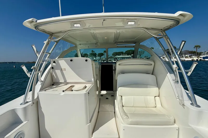 Slide: The Image of 2007 Tiara Yachts 3000 Open cockpit with seating, docked in a marina under clear skies. - 52