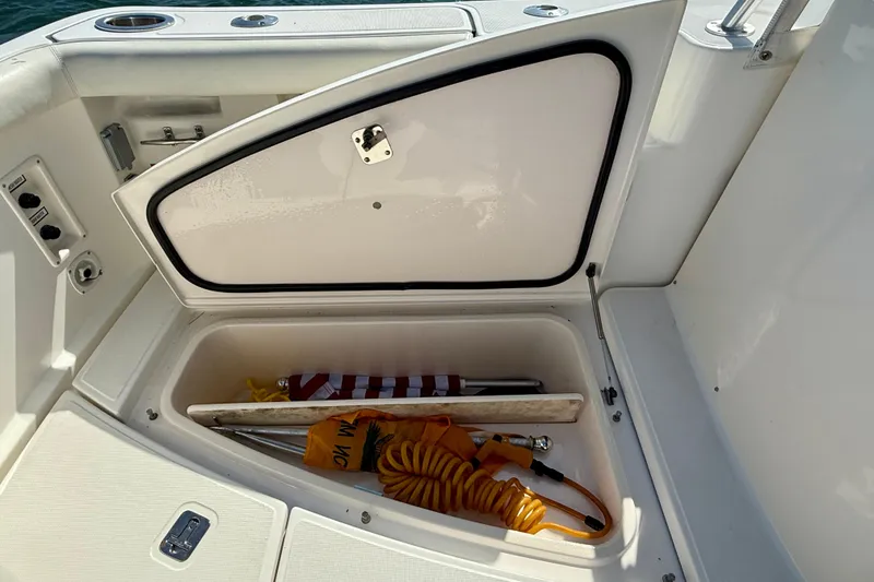 Slide: The Image of Open storage compartment on a 2007 Tiara Yachts 3000 Open, containing boating accessories. - 55