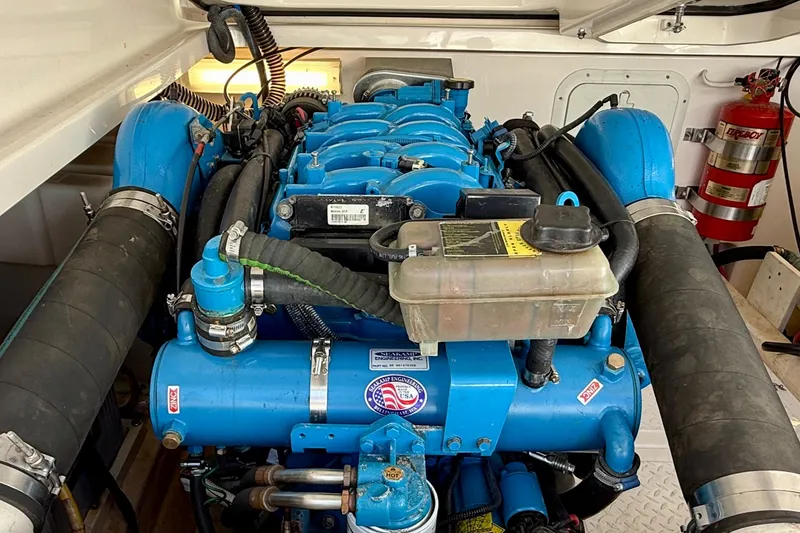 Slide: The Image of Engine compartment of a 2007 Tiara Yachts 3000 Open, featuring a blue marine engine. - 59