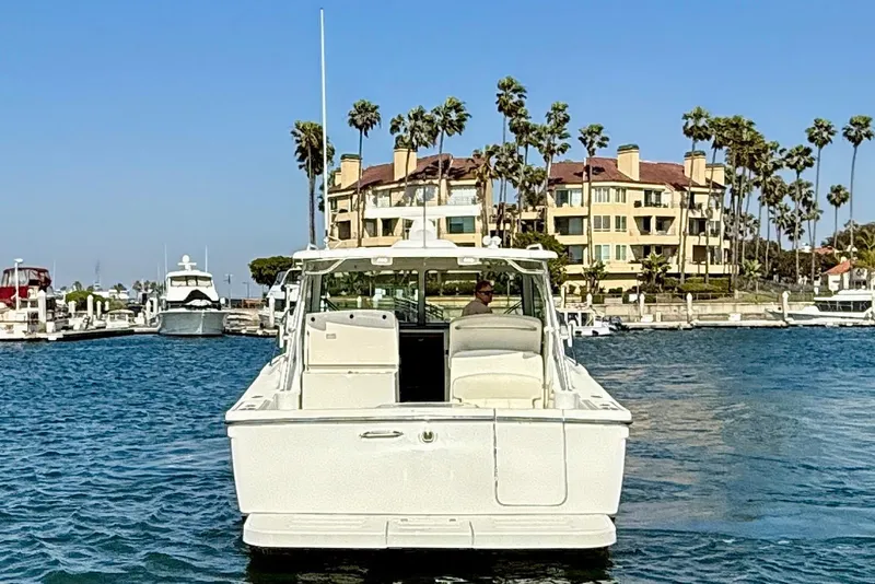 Slide: The Image of 2007 Tiara Yachts 3000 Open in marina, with waterfront buildings and palm trees. - 6