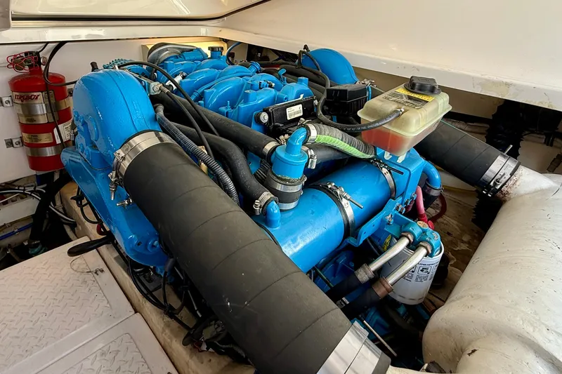Slide: The Image of Engine compartment of a 2007 Tiara Yachts 3000 Open, featuring a blue marine engine. - 61