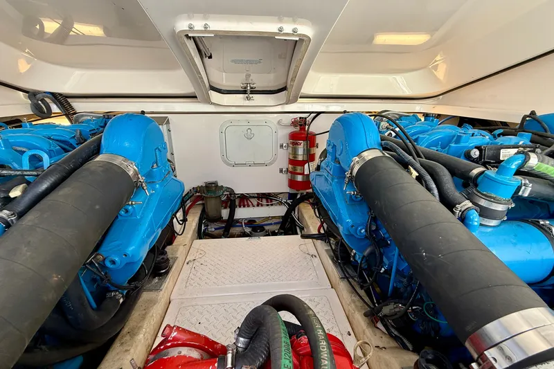 Slide: The Image of Engine room of 2007 Tiara Yachts 3000 Open, featuring dual blue engines. - 62