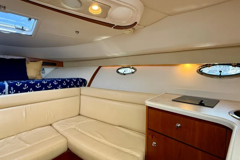 Slide: The Image of Interior of 2007 Tiara Yachts 3000 Open with cozy seating and compact kitchenette. - 8