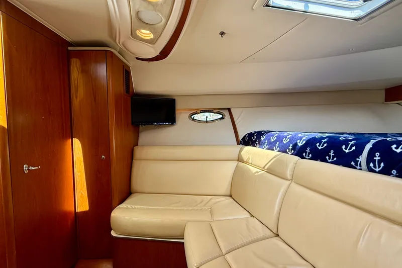 Slide: The Image of Luxurious interior of 2007 Tiara Yachts 3000 Open with beige seating and nautical decor. - 9