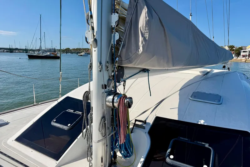Slide: The Image of Nautitech 47 catamaran from 2009 docked in a serene marina setting. - 107