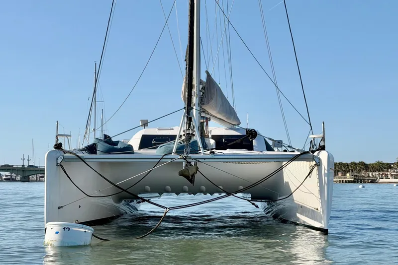 Slide: The Image of Front view of a 2009 Nautitech 47 catamaran on calm water. - 11