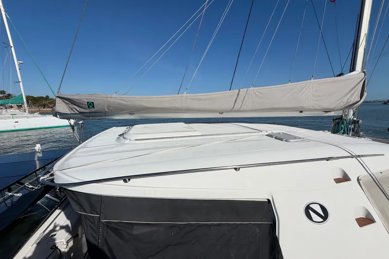 Slide: The Image of 2009 Nautitech 47 catamaran with covered sails, docked on a sunny day. - 110