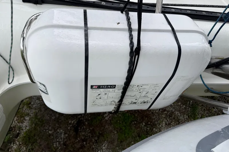 Slide: The Image of White life raft on a 2009 Nautitech 47 catamaran, secured with black straps. - 113
