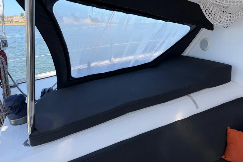 Slide: The Image of Interior seating area of a 2009 Nautitech 47 catamaran with cushioned bench. - 115