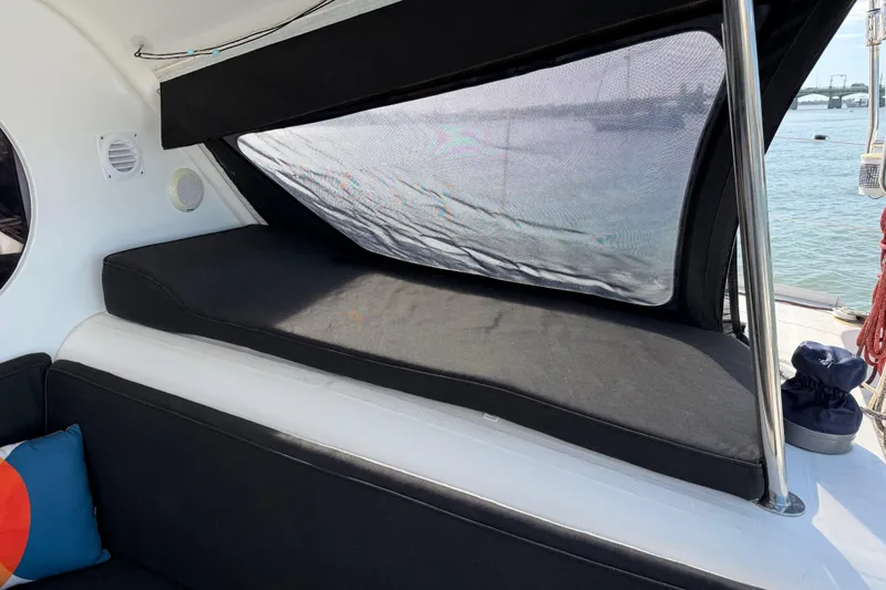 Slide: The Image of Interior view of a 2009 Nautitech 47 catamaran with comfortable seating and window shade. - 116