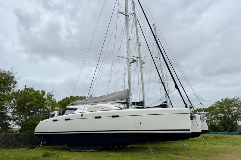 Slide: The Image of 2009 Nautitech 47 catamaran on land, cloudy sky background. - 117