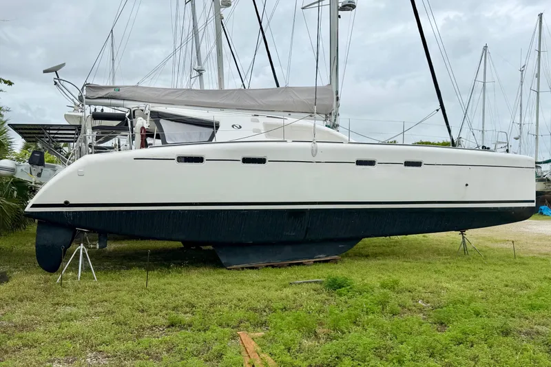 Slide: The Image of 2009 Nautitech 47 catamaran on land, showcasing sleek design and spacious deck. - 118