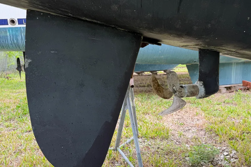 Slide: The Image of Close-up of a Nautitech 47 catamaran's propeller and rudder, 2009 model, on dry land. - 119