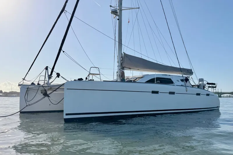 Slide: The Image of 2009 Nautitech 47 catamaran sailing on calm waters under clear skies. - 13
