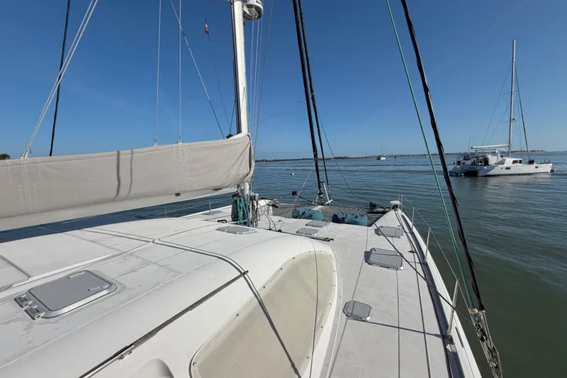 Slide: The Image of Sailing catamaran Nautitech 47, 2009 model, anchored in calm waters under clear blue skies. - 19