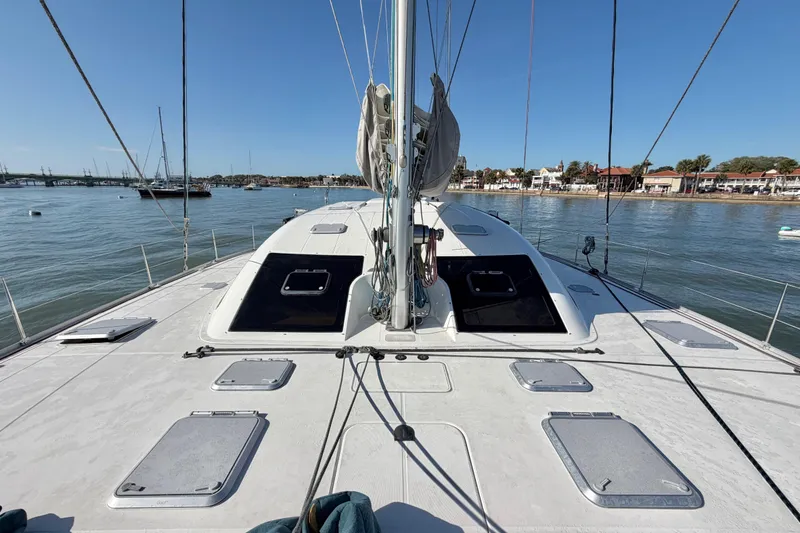 Slide: The Image of 2009 Nautitech 47 catamaran deck view, anchored near coastal town. - 23