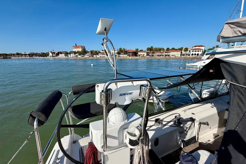 Slide: The Image of Nautitech 47 catamaran, 2009 model, docked with scenic waterfront view. - 26