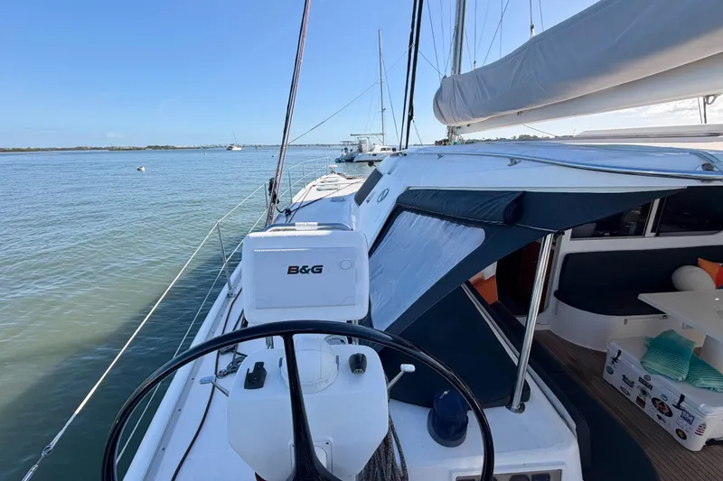 Slide: The Image of Sailing yacht Nautitech 47, 2009 model, with helm and cockpit view on calm waters. - 29
