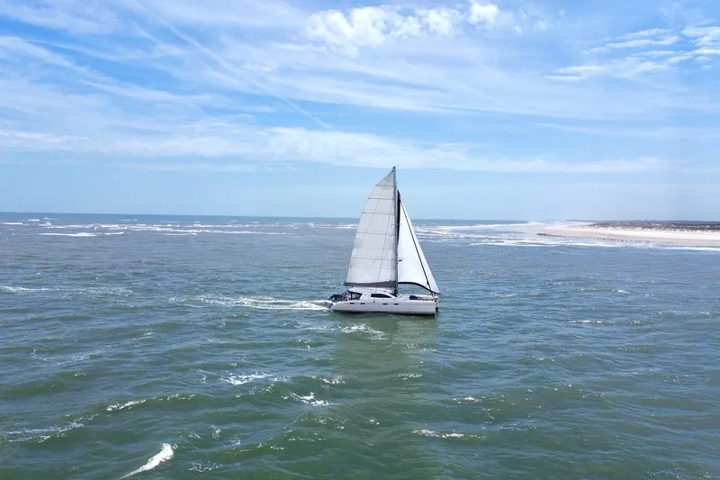 Slide: The Image of Sailing catamaran Nautitech 47, 2009 model, cruising on open sea under clear skies. - 3