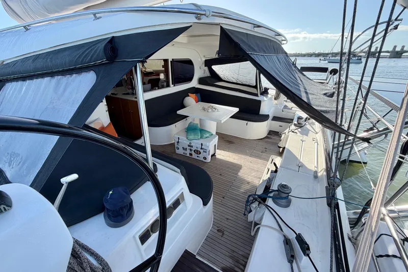Slide: The Image of Spacious deck of 2009 Nautitech 47 catamaran with seating and table, docked at marina. - 30
