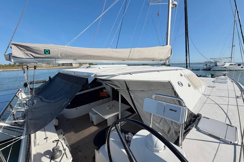 Slide: The Image of 2009 Nautitech 47 catamaran docked, featuring spacious deck and covered cockpit area. - 31