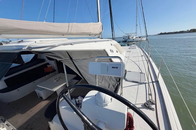 Slide: The Image of Sailing yacht Nautitech 47, 2009 model, docked on calm waters under clear blue sky. - 32
