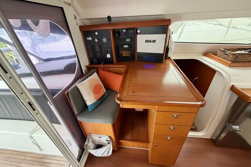 Slide: The Image of Nautitech 47 yacht interior with navigation station, wooden cabinetry, and seating area, 2009 model. - 43