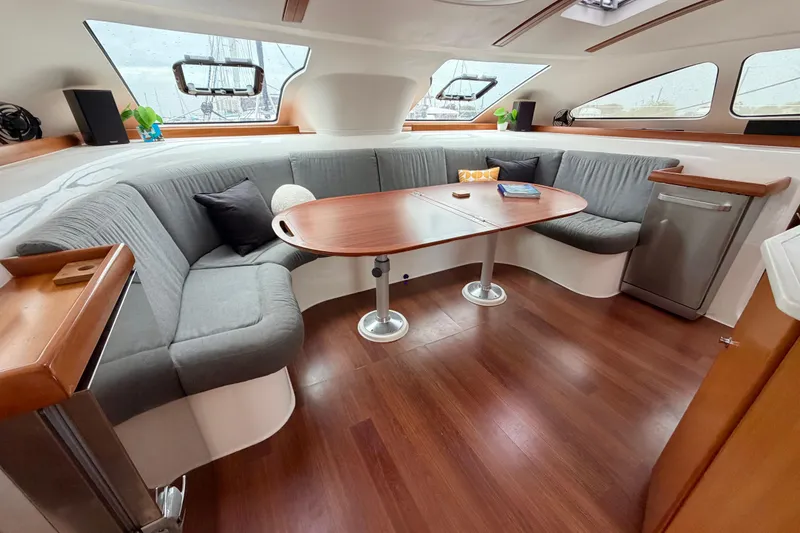 Slide: The Image of Luxurious interior of 2009 Nautitech 47 catamaran with elegant seating and wooden table. - 47