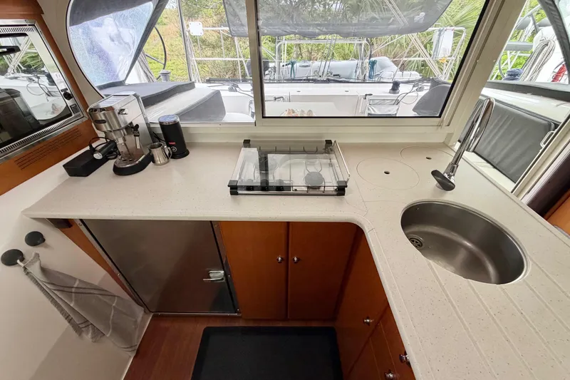 Slide: The Image of Modern kitchen area in a 2009 Nautitech 47 yacht with sink and appliances. - 49