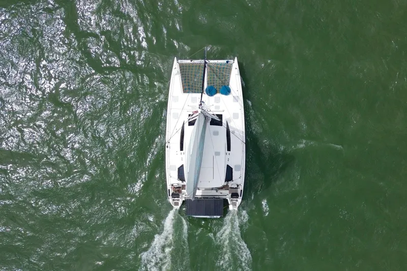 Slide: The Image of Aerial view of 2009 Nautitech 47 catamaran sailing on green ocean waters. - 5