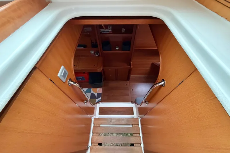 Slide: The Image of Interior view of 2009 Nautitech 47 yacht, featuring wooden stairs and cabin entrance. - 52