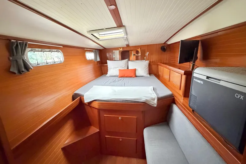 Slide: The Image of Cozy cabin interior of 2009 Nautitech 47 catamaran with wood paneling and comfortable bedding. - 53