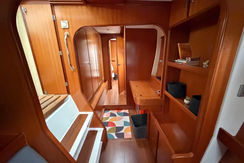 Slide: The Image of Interior of 2009 Nautitech 47 yacht with wooden cabinetry and colorful rug. - 56