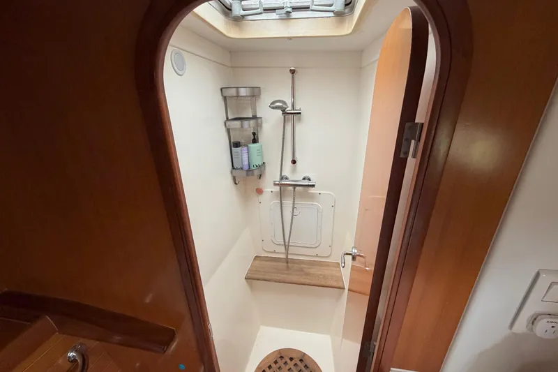 Slide: The Image of Shower area in a 2009 Nautitech 47 catamaran, featuring wooden accents and modern fixtures. - 62