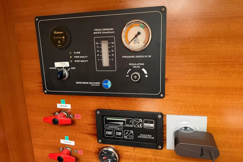 Slide: The Image of Control panel of a 2009 Nautitech 47 yacht, featuring water maker and generator controls. - 65