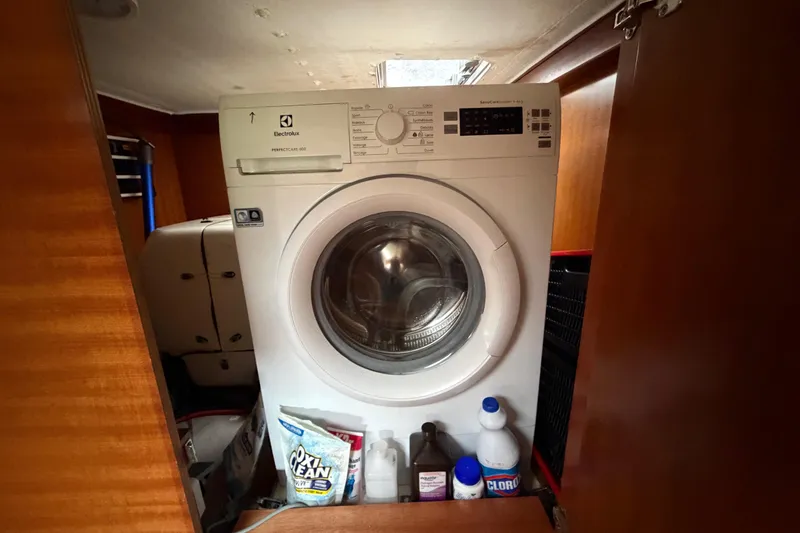 Slide: The Image of Laundry area on a 2009 Nautitech 47 yacht with washing machine and cleaning supplies. - 66
