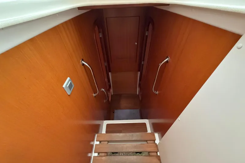 Slide: The Image of Interior staircase of 2009 Nautitech 47 catamaran with wooden finish and handrails. - 68