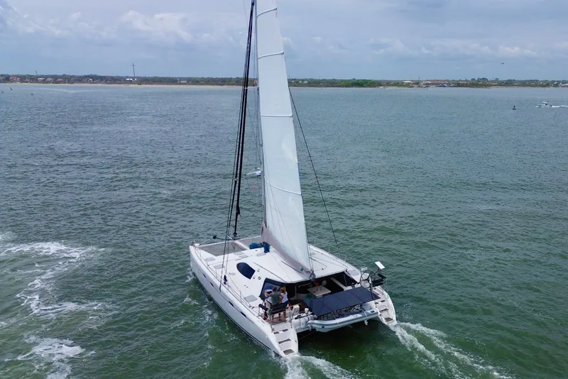 Slide: The Image of Sailing catamaran Nautitech 47, 2009 model, cruising on open water under cloudy skies. - 7