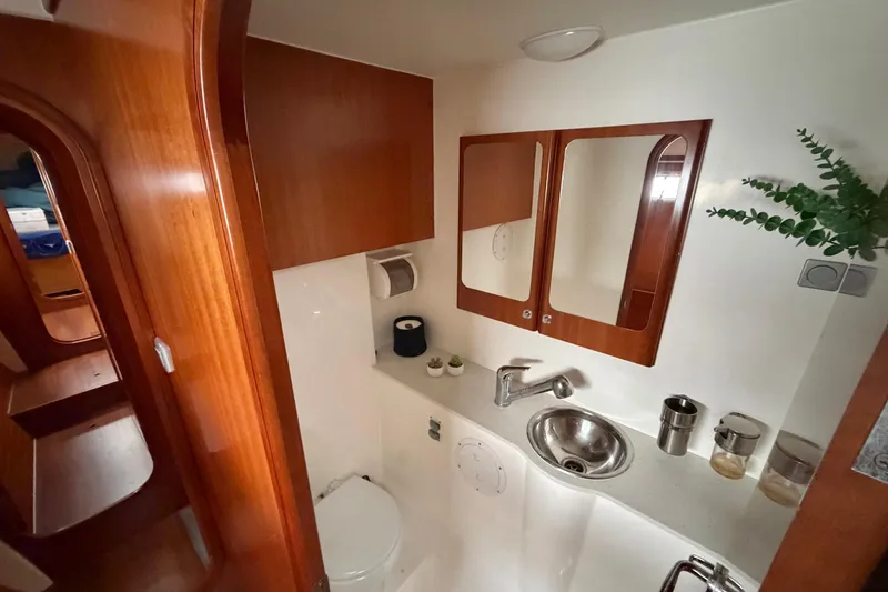 Slide: The Image of Bathroom interior of 2009 Nautitech 47 yacht with wooden cabinetry and stainless steel sink. - 71