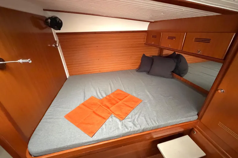 Slide: The Image of Cozy cabin interior of 2009 Nautitech 47 yacht with wooden finish and comfortable bedding. - 72