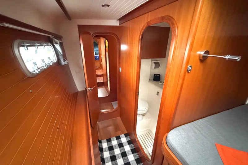 Slide: The Image of Interior of 2009 Nautitech 47 yacht, featuring wooden paneling and compact bathroom. - 73