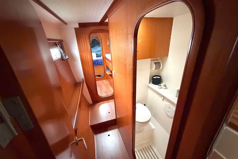 Slide: The Image of Interior of 2009 Nautitech 47 yacht, featuring wooden cabin and compact bathroom. - 74