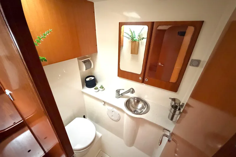 Slide: The Image of Bathroom interior of 2009 Nautitech 47 yacht with sink, mirror, and wooden cabinetry. - 75