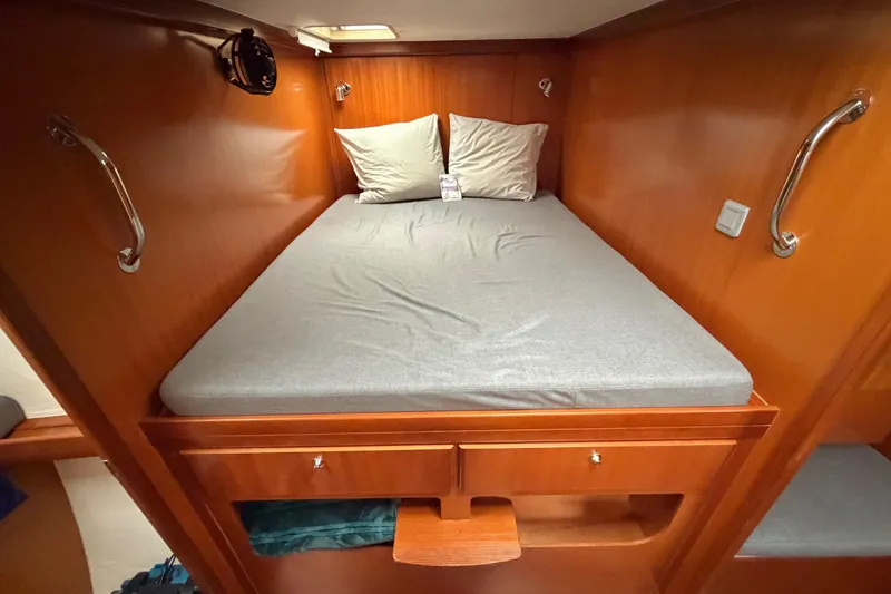 Slide: The Image of Cozy cabin bed in 2009 Nautitech 47 catamaran with wooden interior and soft lighting. - 80