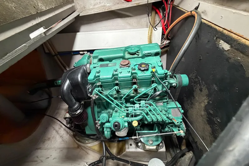 Slide: The Image of Engine compartment of a 2009 Nautitech 47 catamaran, showcasing a green marine engine. - 89
