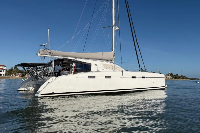 Slide: The Image of 2009 Nautitech 47 catamaran sailing on calm waters under clear blue skies. - 9