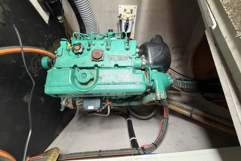 Slide: The Image of Engine compartment of a 2009 Nautitech 47 catamaran, featuring a green marine engine. - 91