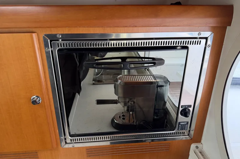 Slide: The Image of Built-in coffee machine on a 2009 Nautitech 47 yacht, set in a wooden cabinet. - 95