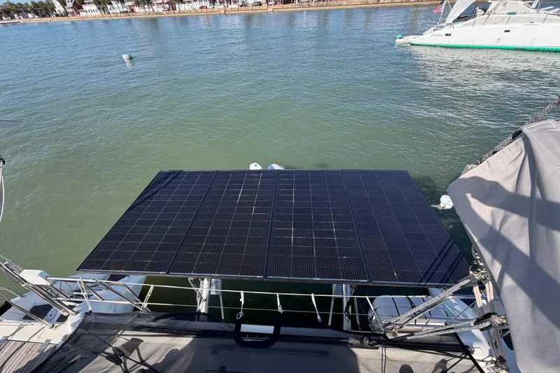 Slide: The Image of Solar panels on a 2009 Nautitech 47 catamaran, docked on calm waters. - 99