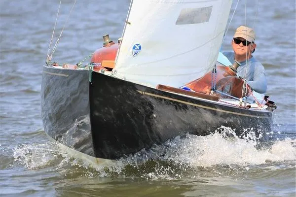 The Image of Sailboat Luders L-16 from 1946 navigating through water with a person onboard. - 0
